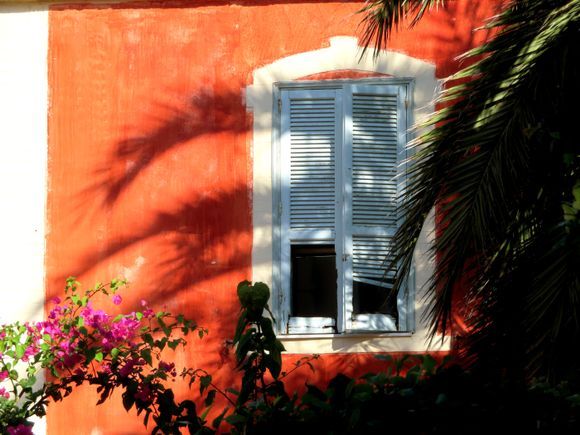  Red facade with palms and bougainvilea. Rodos New Town
