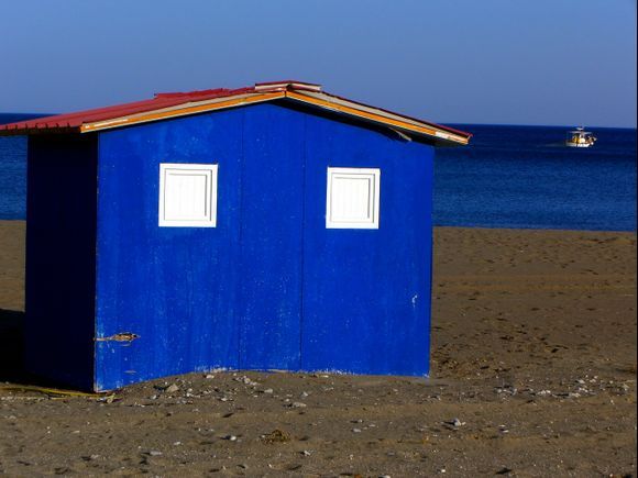 Coastal blue house and small boat, Faliraki beach