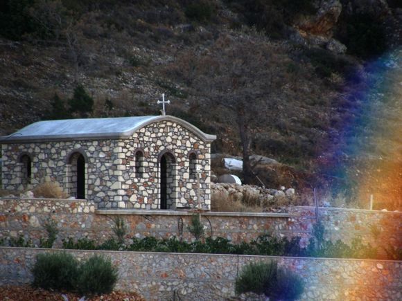 Little church made out of natural stone and a rainbow ?