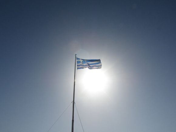 Greek flag in the sun at the castle