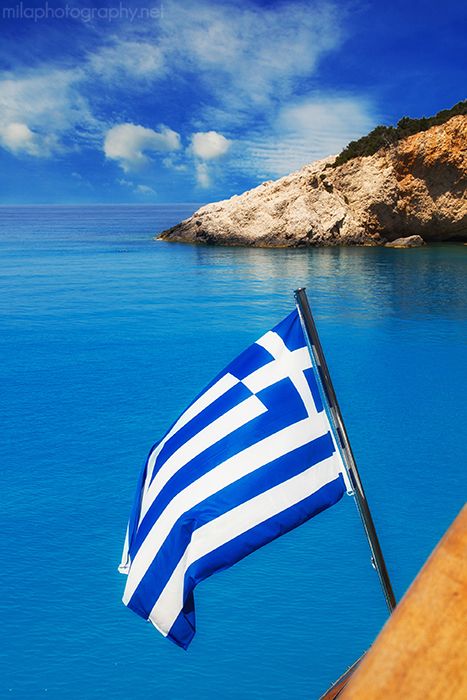Greek flag on a cruise ship with Porto Katsiki beach in the background