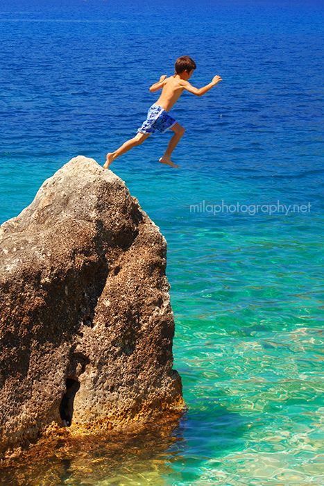 Boy jumping in the water