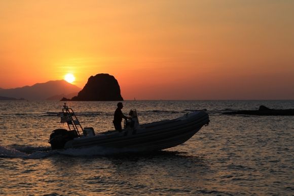 Sunset in Pollonia with Makis and his boat