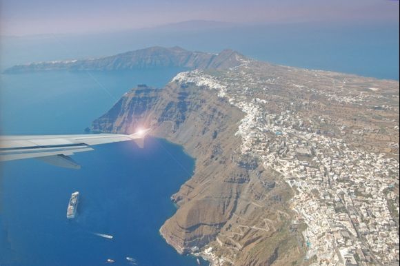 Fira, Imerovigli and in distance Oia seen from the sky.