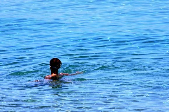 swimmer in blue waters