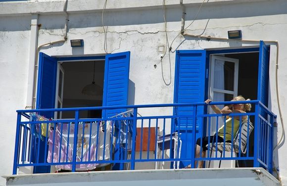blue shutters and wet laundry in the sun