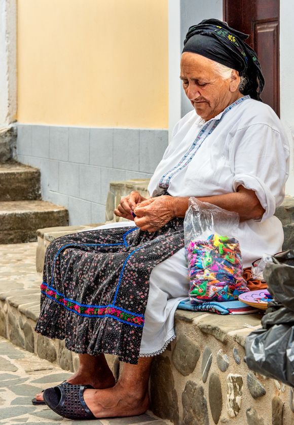 Woman stringing beads