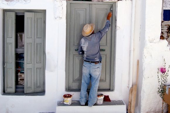 I local man paints his home (unfortunately a photo is not capable of capturing the instructions this man\'s wife was shouting to him from within the house!)