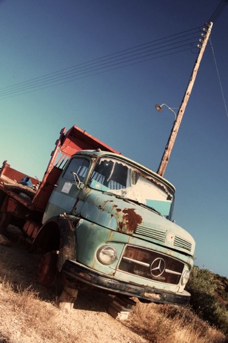 an old truck on the side of the road