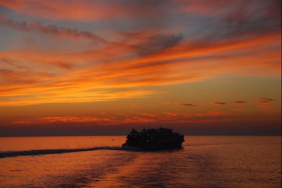 High Speed ferry leaving Parikia port in sunset