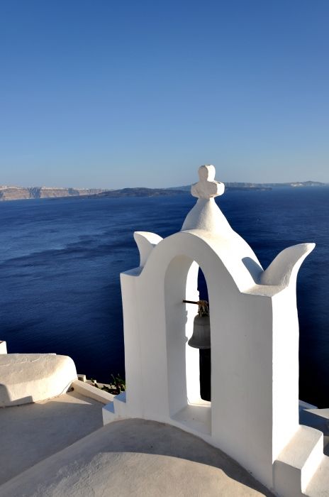 I love the sun hits Santorini\'s houses and churches. This is somehow the most beautiful moment the camera can capture. It reminds me how amazing Santorini is.