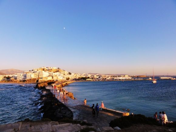 view of Naxos town as tourists walk to and from the Portara.