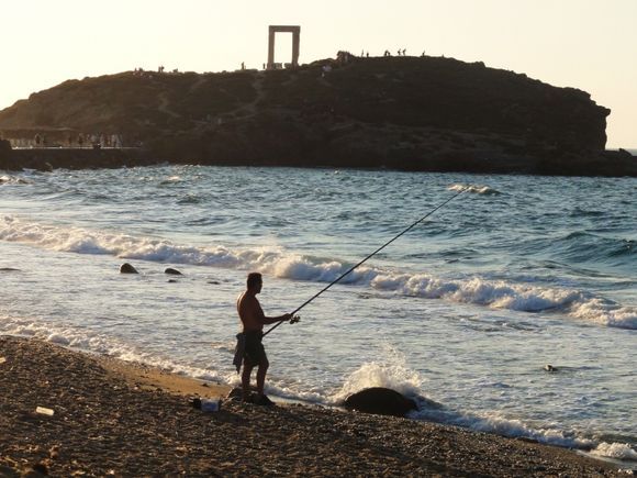 man fishing in Naxos Town