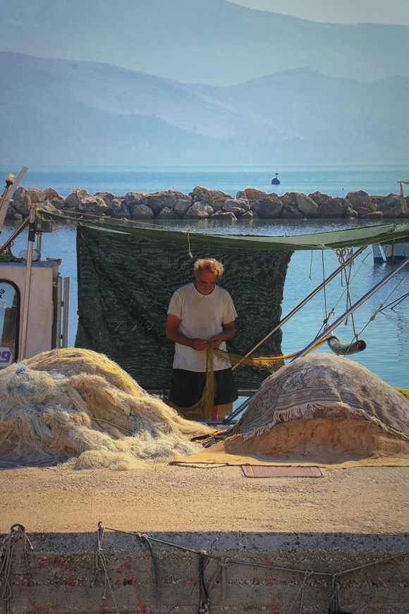 mending fishing nets in lixouri on the island of kefalonia