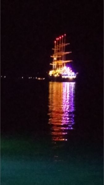 A lit up sailboat pleasure cruiser of the Milos port