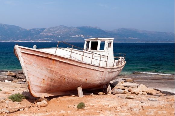 A weathered fishing boats basks under the intense Mediterranean sun on the beautiful island of Elafonissos.