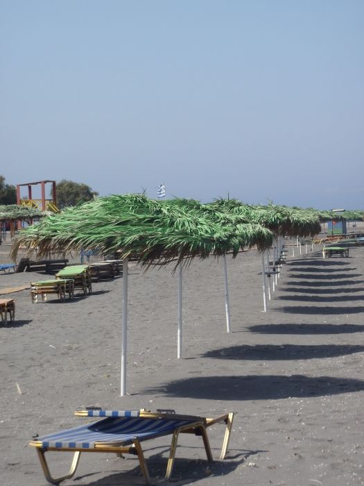 The green umbrellas at Monolithos Beach remind me of Dr Szuiz!