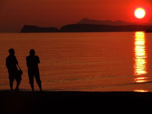 A couple by sunset on Arillas bay
