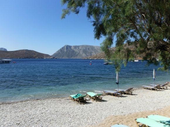 Telendos island, the quiet beach close to the small harbour of the island