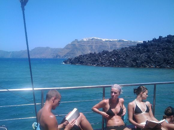 Santorini, tour boat to the Volcano Nea Kameni. In the background the view of Firostefani and Imerovigli.