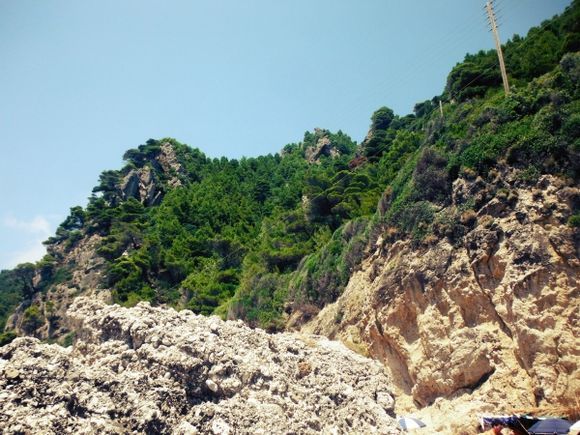 Corfu island, the naturist Myrtiotissa is a sandy paradise surrounded by the magestic landscape of lush green cliffs and crystalline waters.