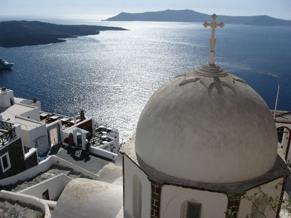 Santorini a great view from Fira, the Volcano NEA KAMENI in the left and Thirasia island in front of the Catholic Church.