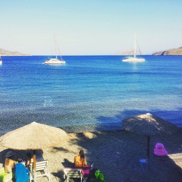 Leros july 2015, Alinda is located 3 km north west of Agia Marina and is the longest beach of Leros. Also this is one of the best organized areas with numerous facilities, leisure activities, plenty of water sports and fish taverns. The beach is only a short walk away from the settlement and consists of soft sand and crystalline waters. Pine trees are spread around the sandy coast providing nice shade. For those who want to avoid the summer crowds some quitter sandy coves are scattered around the main beach, such as the romantic beach of Krifo.