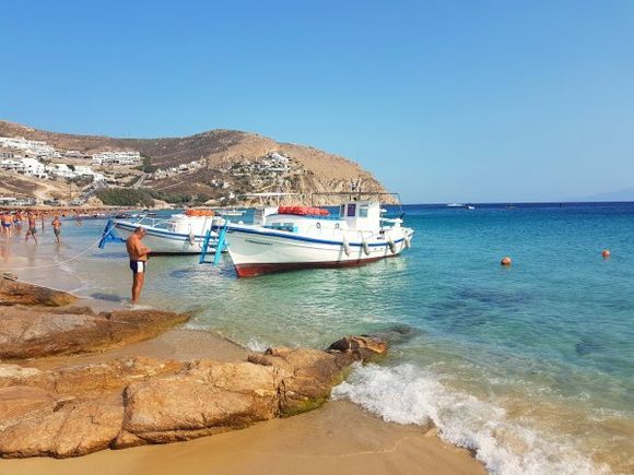 Mykonos august 2017, Elia is the last stop on the caique (traditional fishing boat used as taxi boat) so slightly quieter. Lots of nudists come here. It is a quiet beach unlike Paradise, Super Paradise and others. There is a nice view to the left up the hill, enjoy the traditional Cycladean houses.