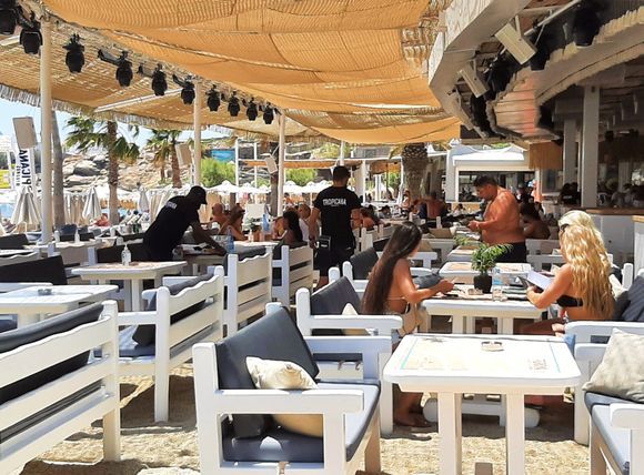 Mykonos July 2021, The Tropicana beach bar and restaurant is located on Paradise beach, Tropicana Club is one of the most popular beach bars of Mykonos Island. Beautiful surroundings, exotic cocktails and sumptuous meals make this one of the most sought-after destinations for party-goers from around the globe.