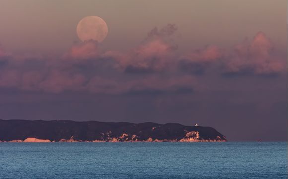 Moon set over Othonoi 22km away from Agios Stefanos. Was waiting for the moon to sit on top of the light house but cloud got in the way...