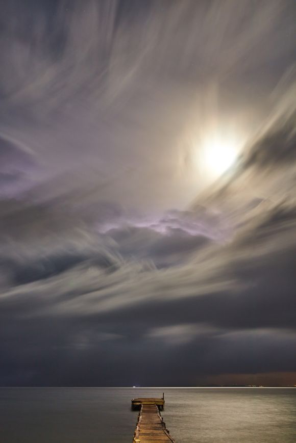 A view from a jetty at night.  Love the sky. Storm light and moon light with layers of cloud, Messonghi