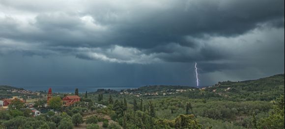 Storms are about. Looking from Agyrades over Neochoraki, Petriti in the far left and Noto's and Agios Nikolaos to the right and a strike at the end of Alikes salt pans...     