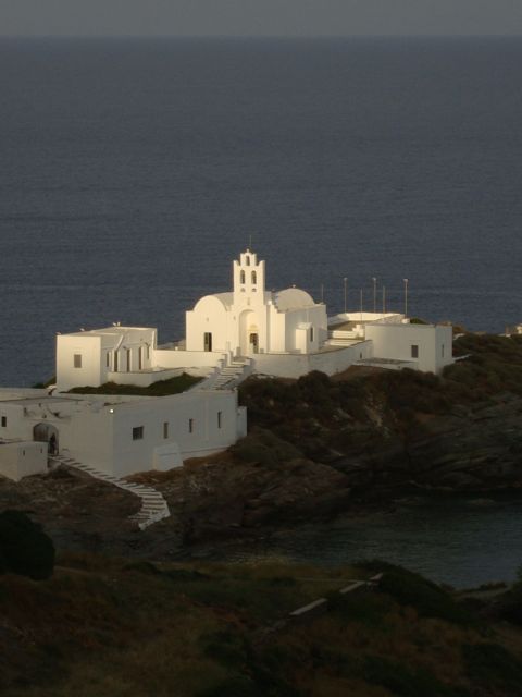 I walked outside our room overlooking the cove at Chryssopigi just before dusk;  With the sun setting over the hill above and behind us, the Monastery took on a magic glow as the shadow line approached