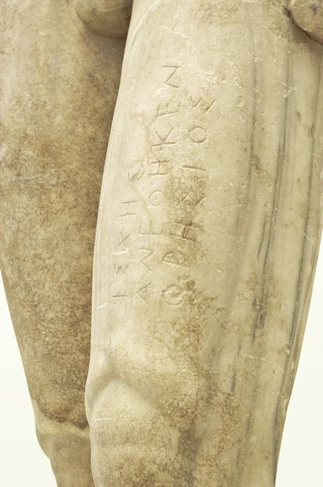 Ancient script on kouros legs - Vathi Museum samos