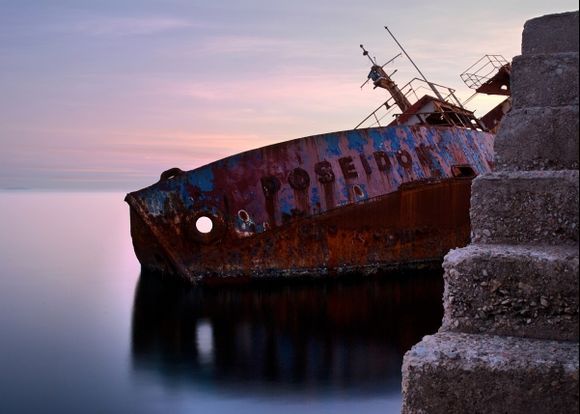 The shipwreck of  Poseidon lays in rust for many years now,near the new marina of Faliro in Piraeus.