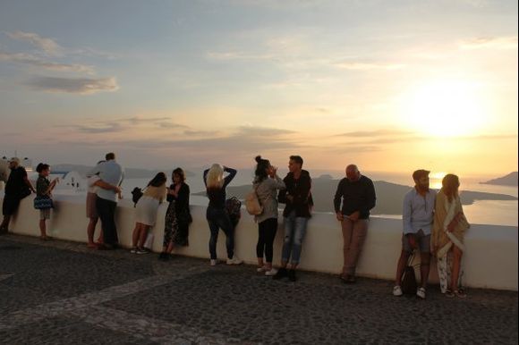 People gather to watch the sunset in Oia.