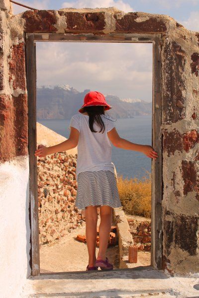 A girl admires the view in the village of Oia.