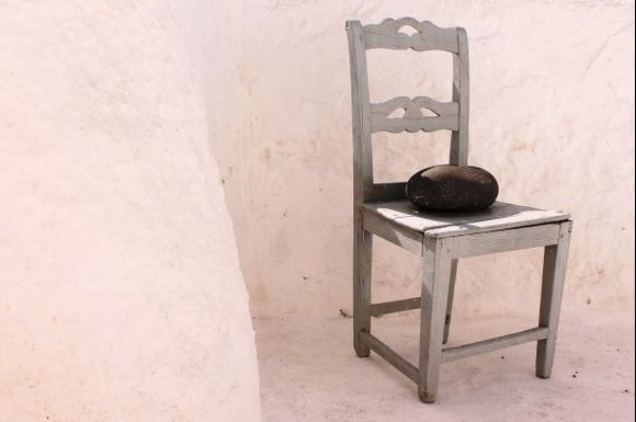 A lava stone is placed on a chair in the village of Pyrgos.