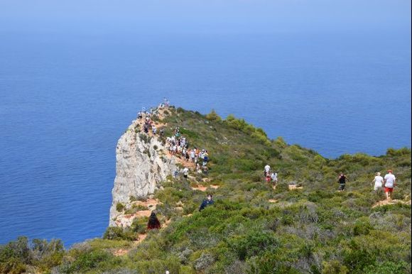 People walking till the end, to get the best view of Navagio Beach