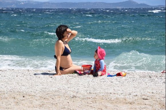 Mother playing with child at the beach