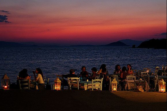 People having diner in Aegina town, next to the sea, on Aegina island.