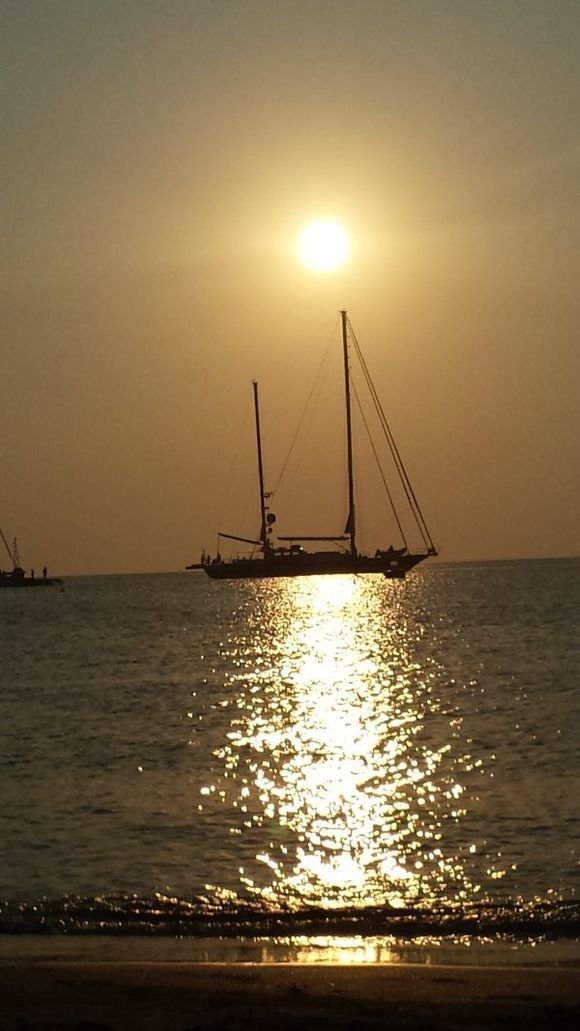 Boat sailing as the sun sets , Sifnos