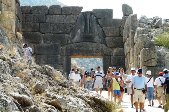 The ancient \'Lion\'s gate\' in Mycenae with it\'s many tourists coming and going.