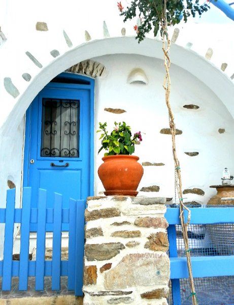 Grecian blue boldly accents this beautiful stone and stucco home, in the mountainous village of Lefkes, Paros, Greece.