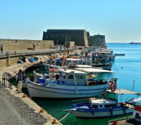 Brightly striped fishing boats line the pier leading to Koules, Heraklion's famous, Venetian fortress, (1523 - 1540)