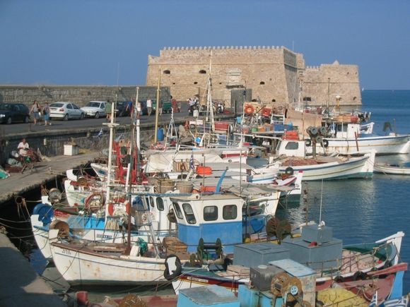 Boats on the harbour arm near Koules castle in Heraklion, Crete